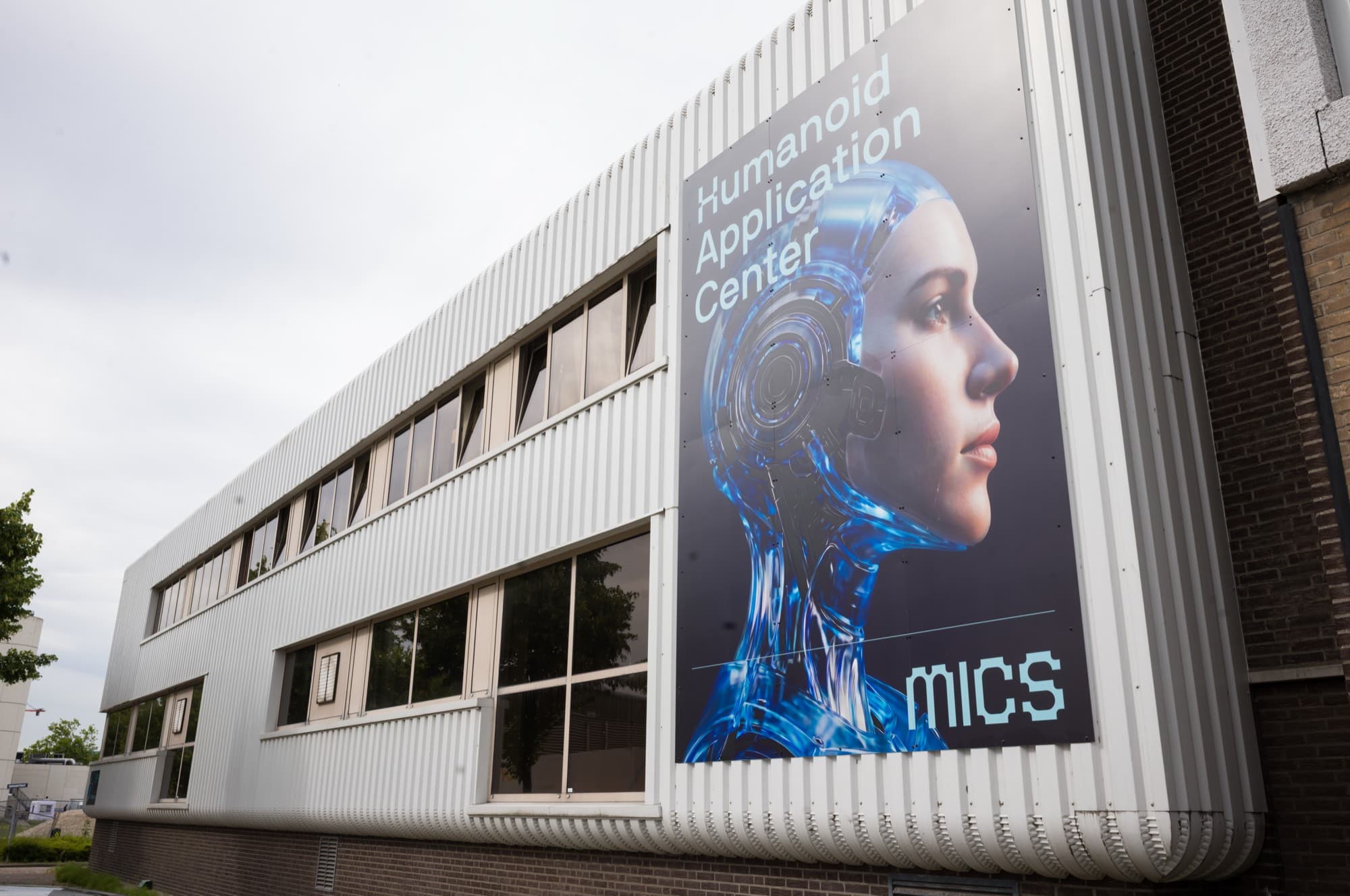 The facade of the MICS building on Conradstraat in Schiedam with the large HAC banner